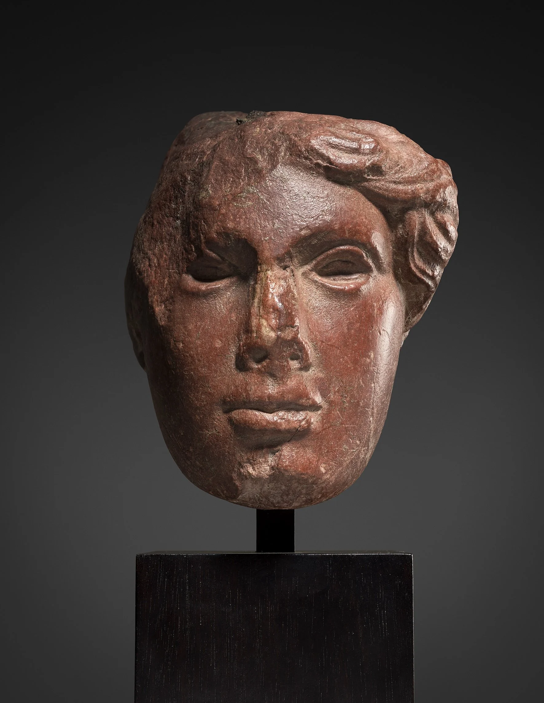 Roman Rosso Antico head of Athena
1st/2nd century AD
Height: 15 cm, 
Private collection, Switzerland; acquired 1960s, and thence by descent