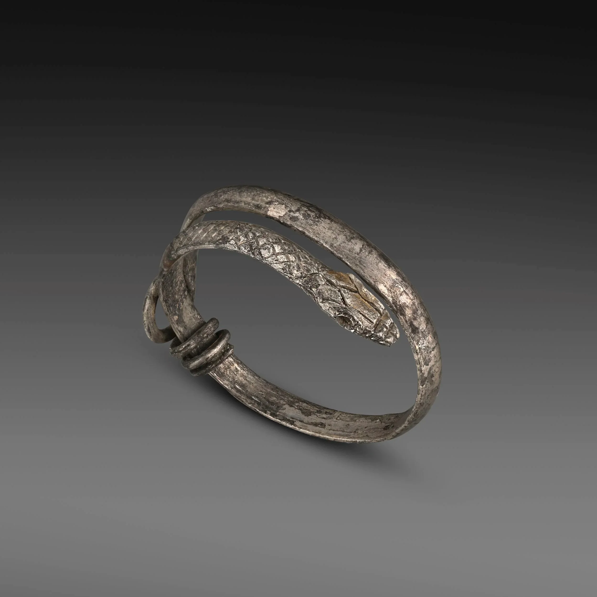 Romano-Egyptian silver snake ring with engraved head and tail