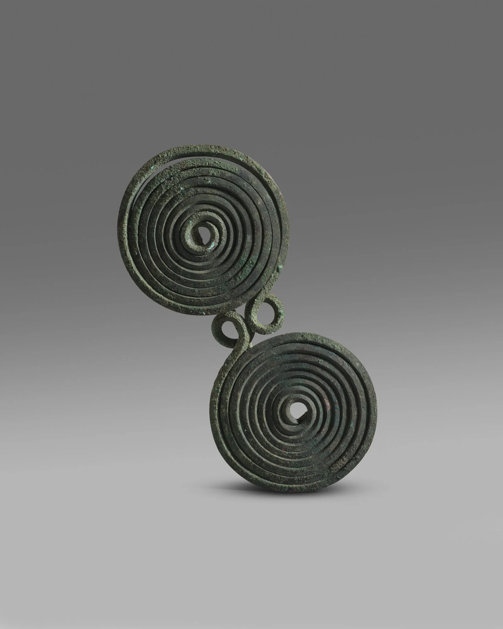 Double ' spectacle' spiral fibula
Bronze Age, Geometric Greek 8th-7th century BC
height: 15.6 cm; width: 7.3 cm
UK Private Collection.