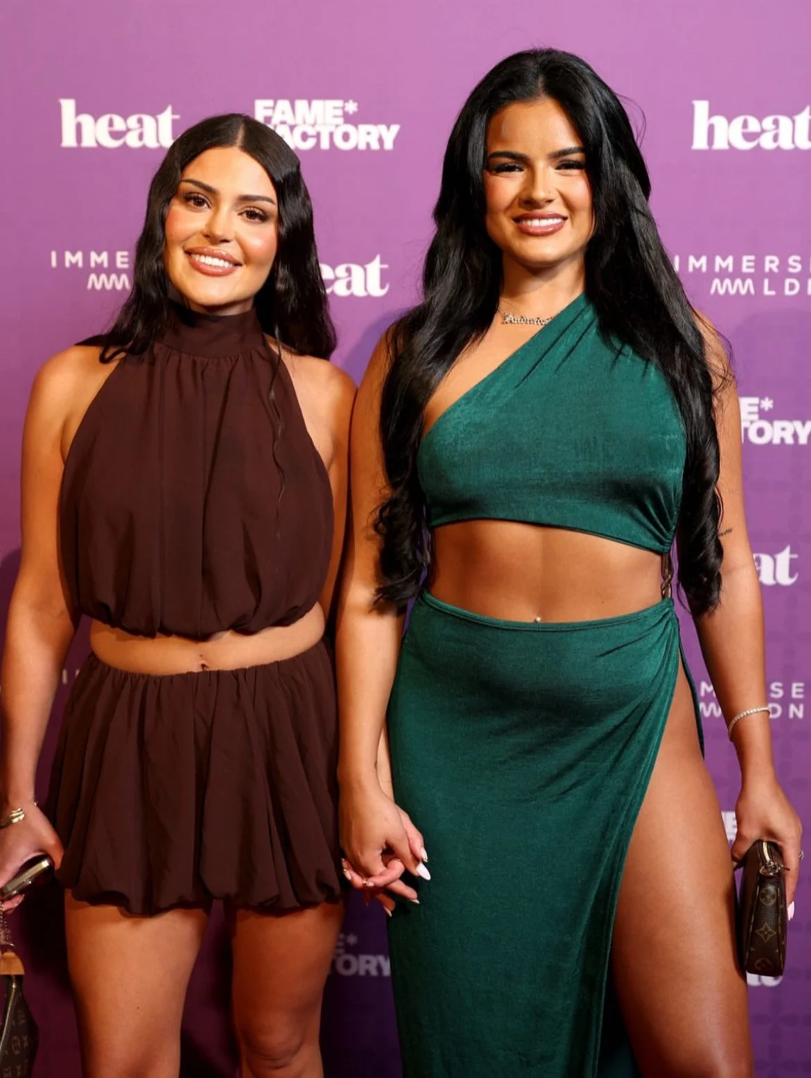 A young man in a black suit and black shirt standing on a red carpet at a promotional event for the movie 'Gladiator II.' The background is decorated with the movie's logo, banners, and sponsor logos.