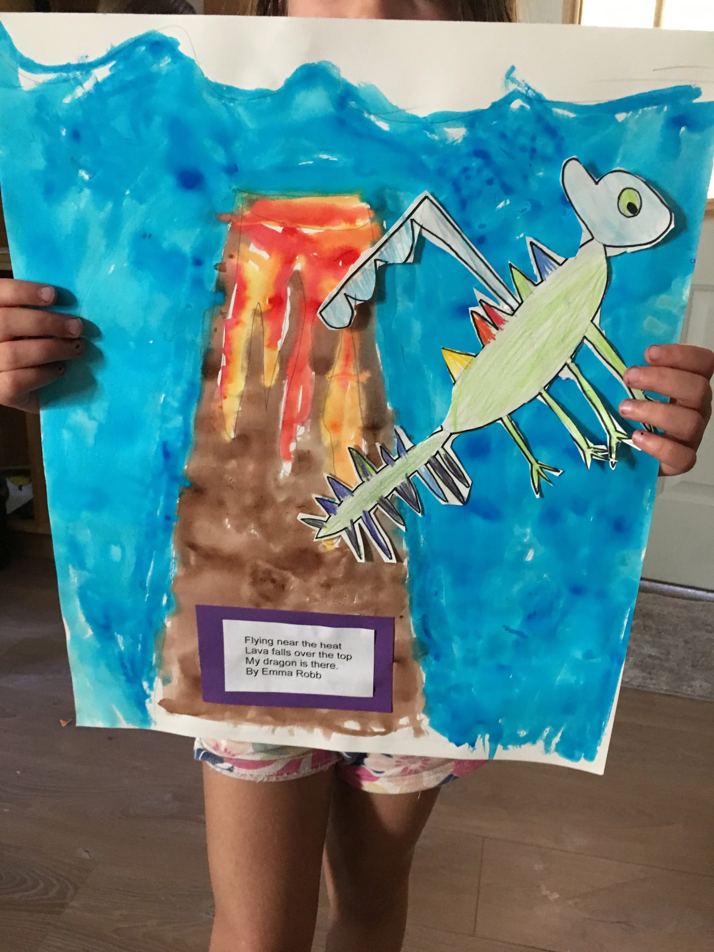 Children's colorful drawing of a volcano erupting with lava, a green dragon flying nearby, blue sky background, and a poem titled 'Flying near the heat'.