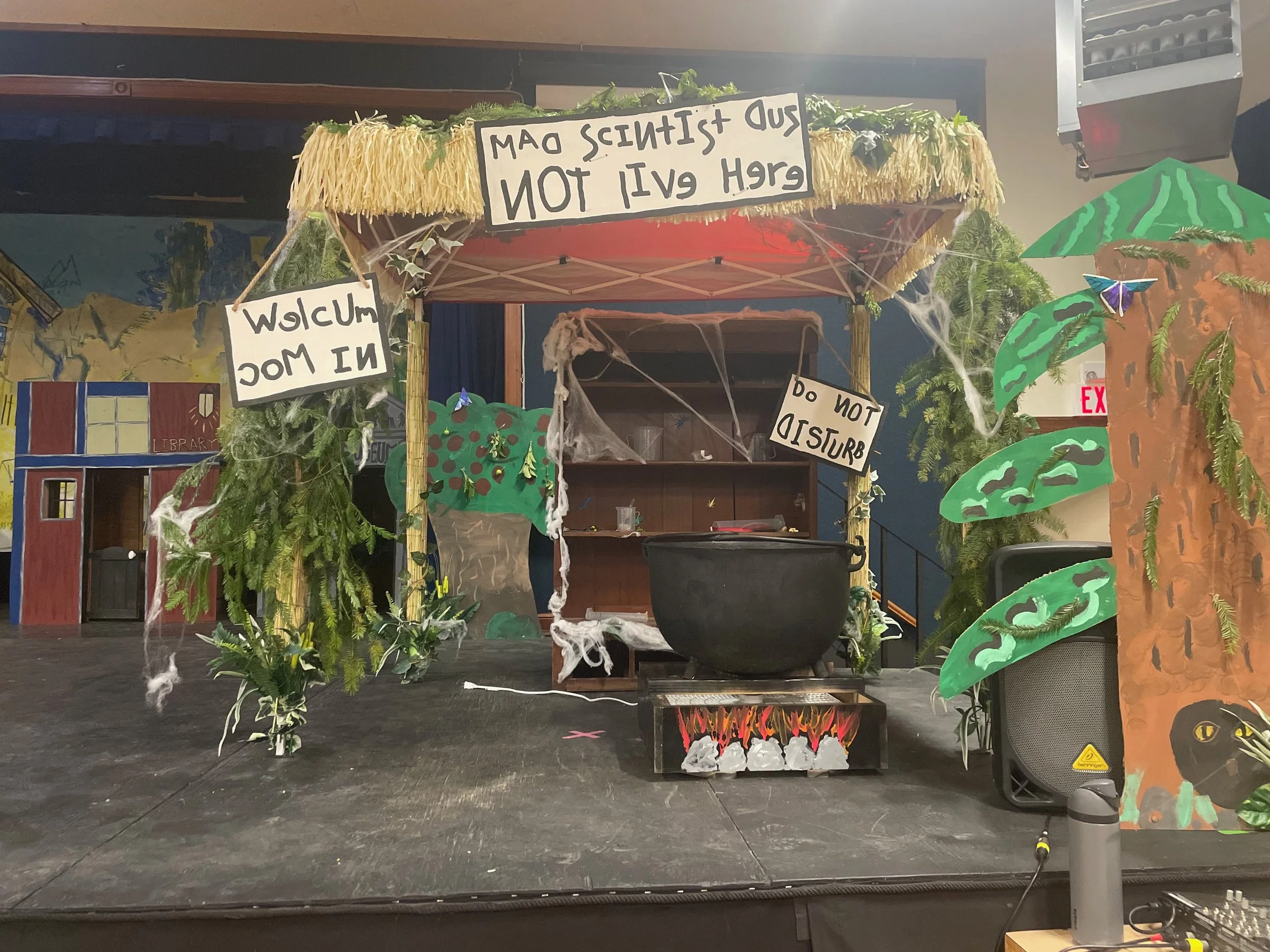Stage decorated to look like a jungle or outdoor scene.