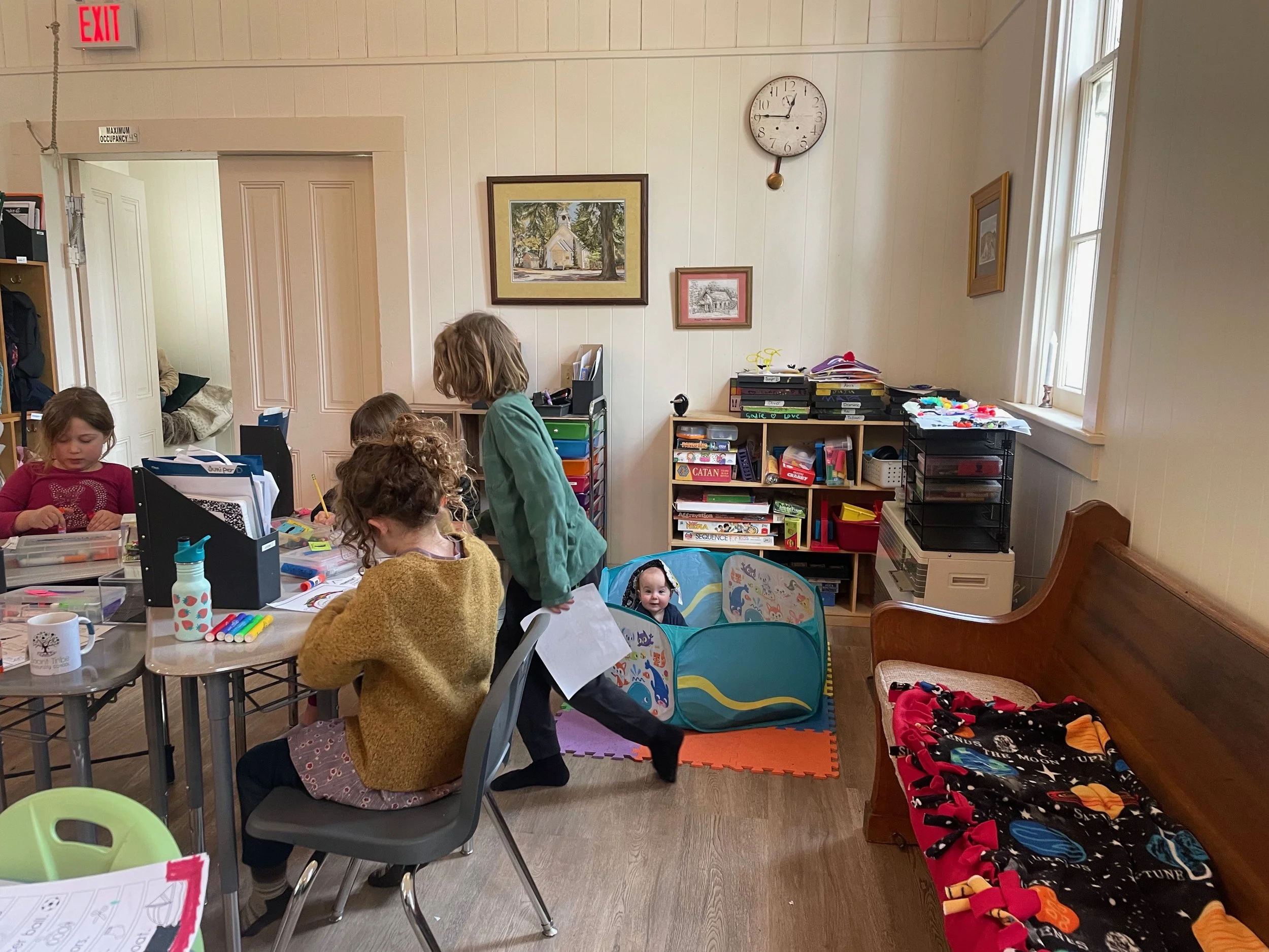 Children in a classroom engaging in activities.