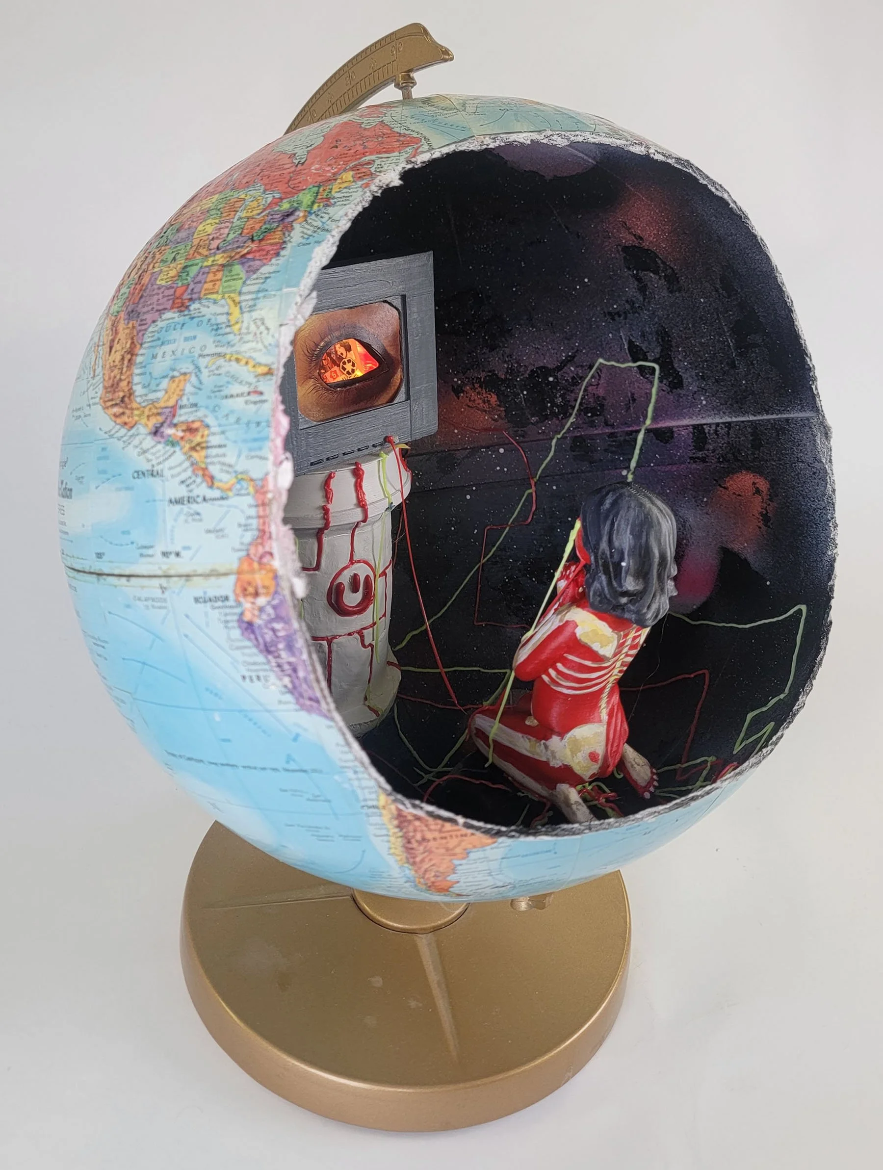 Television or Tell a Vision, Recycled globe, clay, PLA filament, acrylic paint, spray paint, collage and this artwork contains LED lights that can turn ON/OFF, 17 in H x 12 in W x 12 in D, 2023