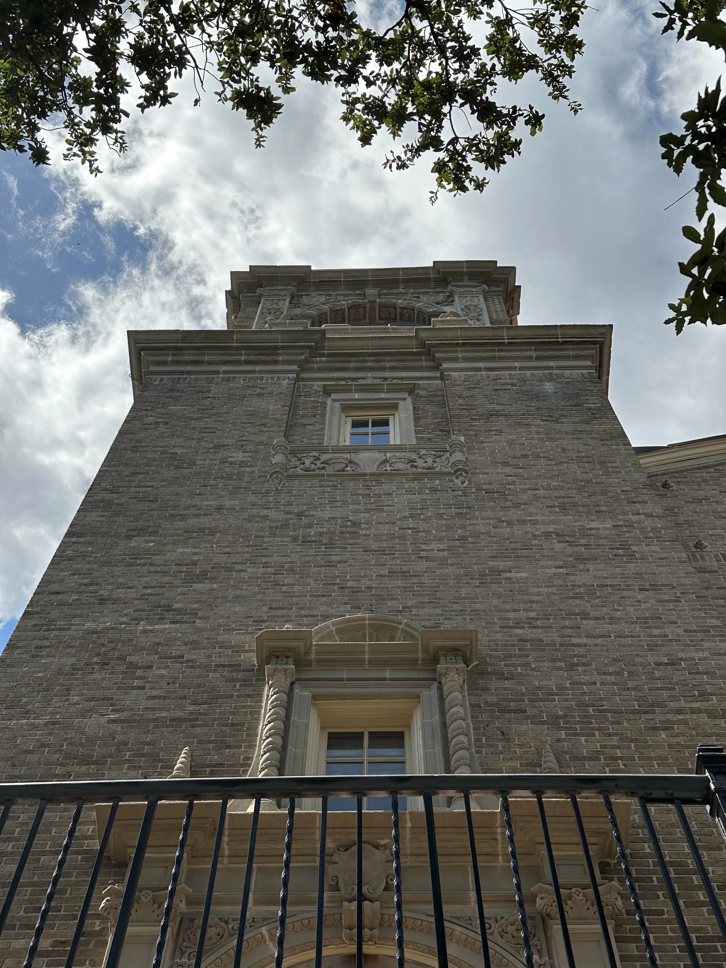Attic under renovation with roofing structure visible, tools, ladder, and construction materials scattered around.