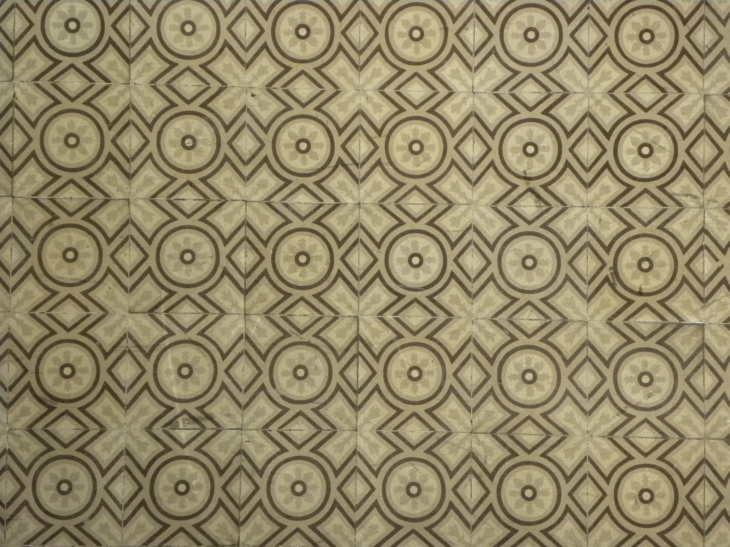 Close-up view of a wooden framework or structure, showing intersecting beams and nails, with the sky and clouds visible in the background.