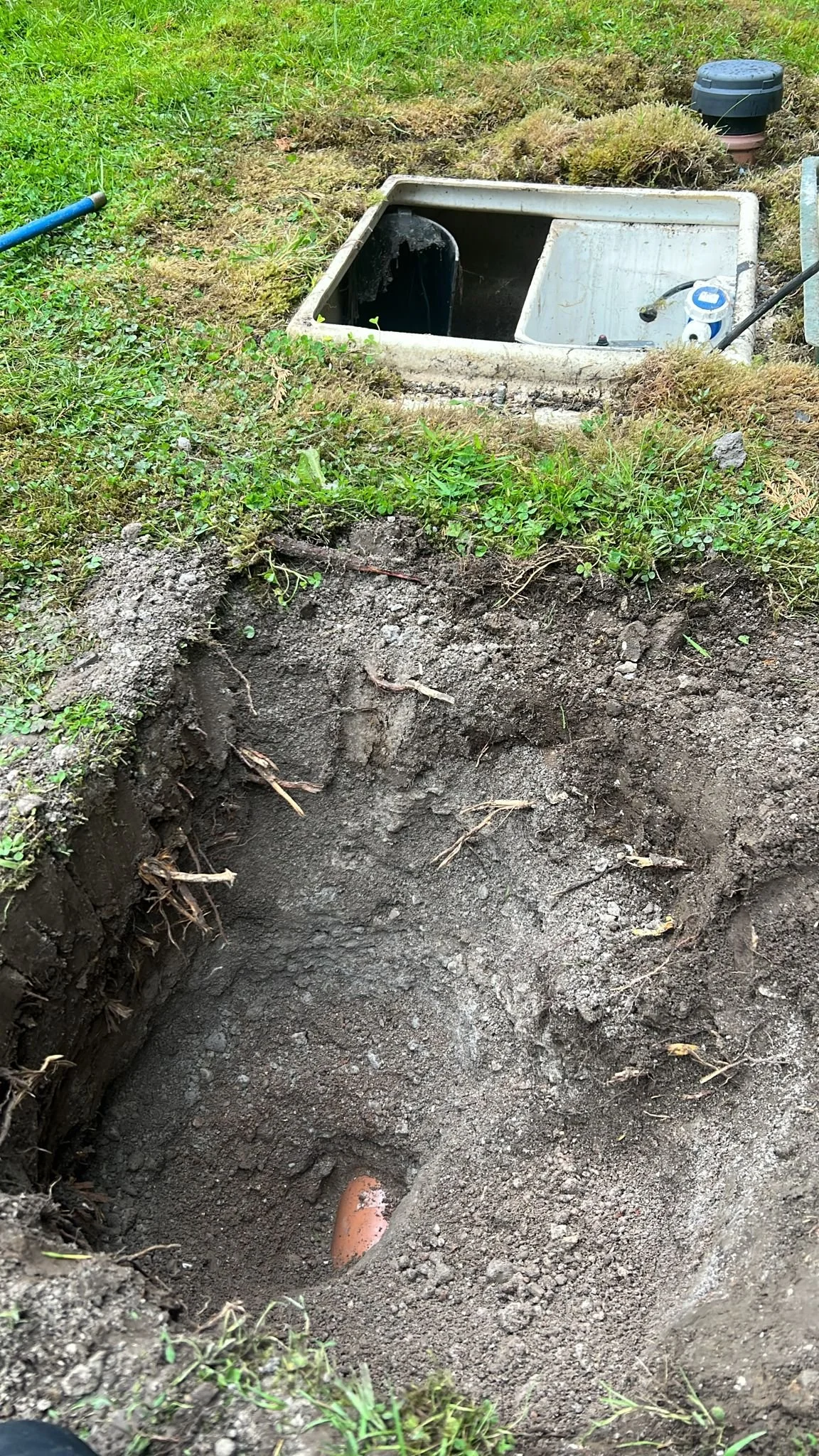 Excavation works exposing outlet pipework from a private water treatment plant during a drainage investigation in Bosley, Cheshire.