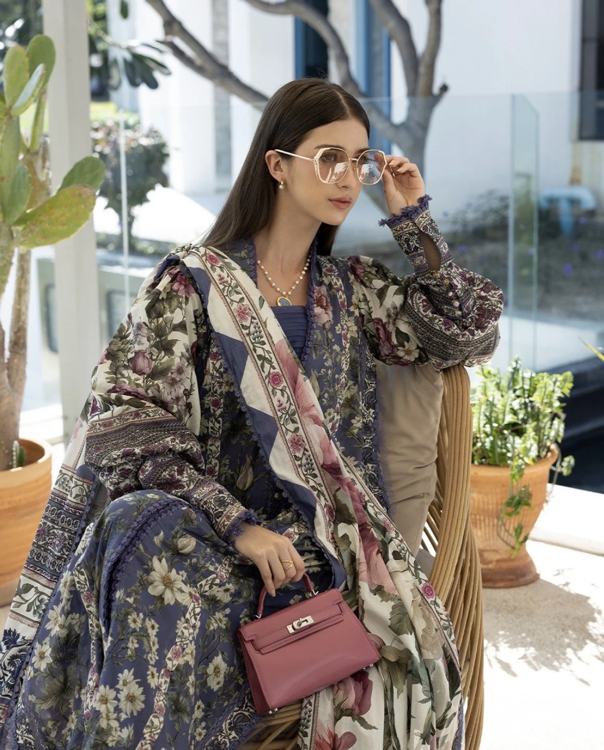 Elegant black chiffon suit adorned with intricate golden embroidery, paired with a delicately embroidered dupatta. Perfect for festive and formal occasions, blending timeless grace with modern sophistication.