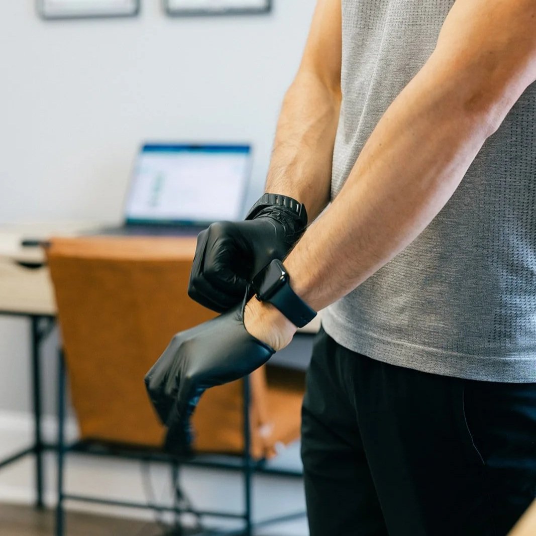 physical therapist at Fine Tuned Performance preparing for soft tissue work