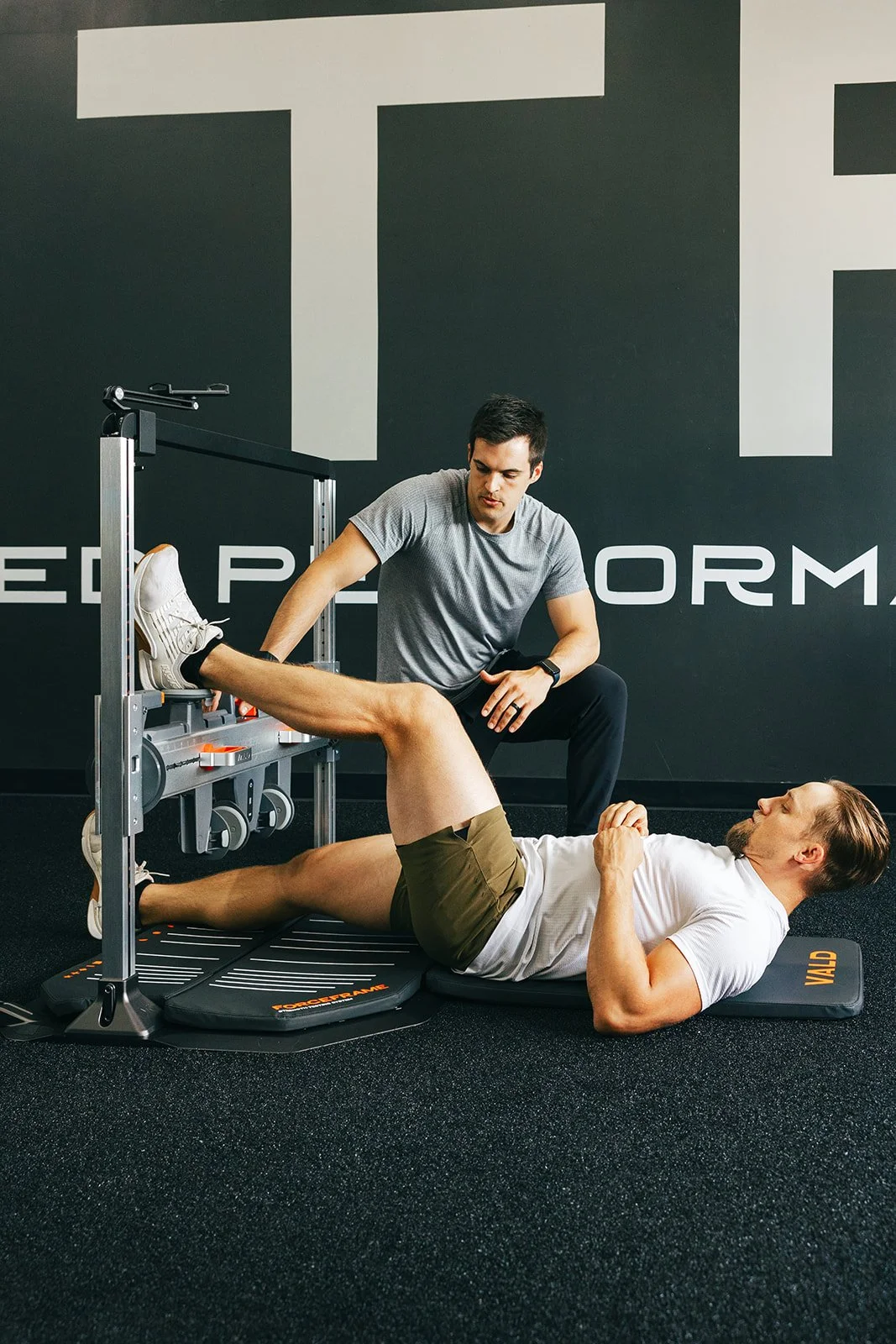 physical therapist gathering strength data with VALD ForceFrame