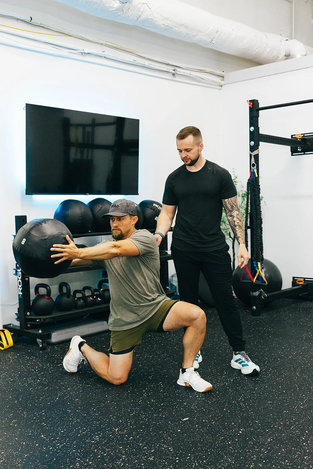 physical therapist supervising exercises in physical therapy office