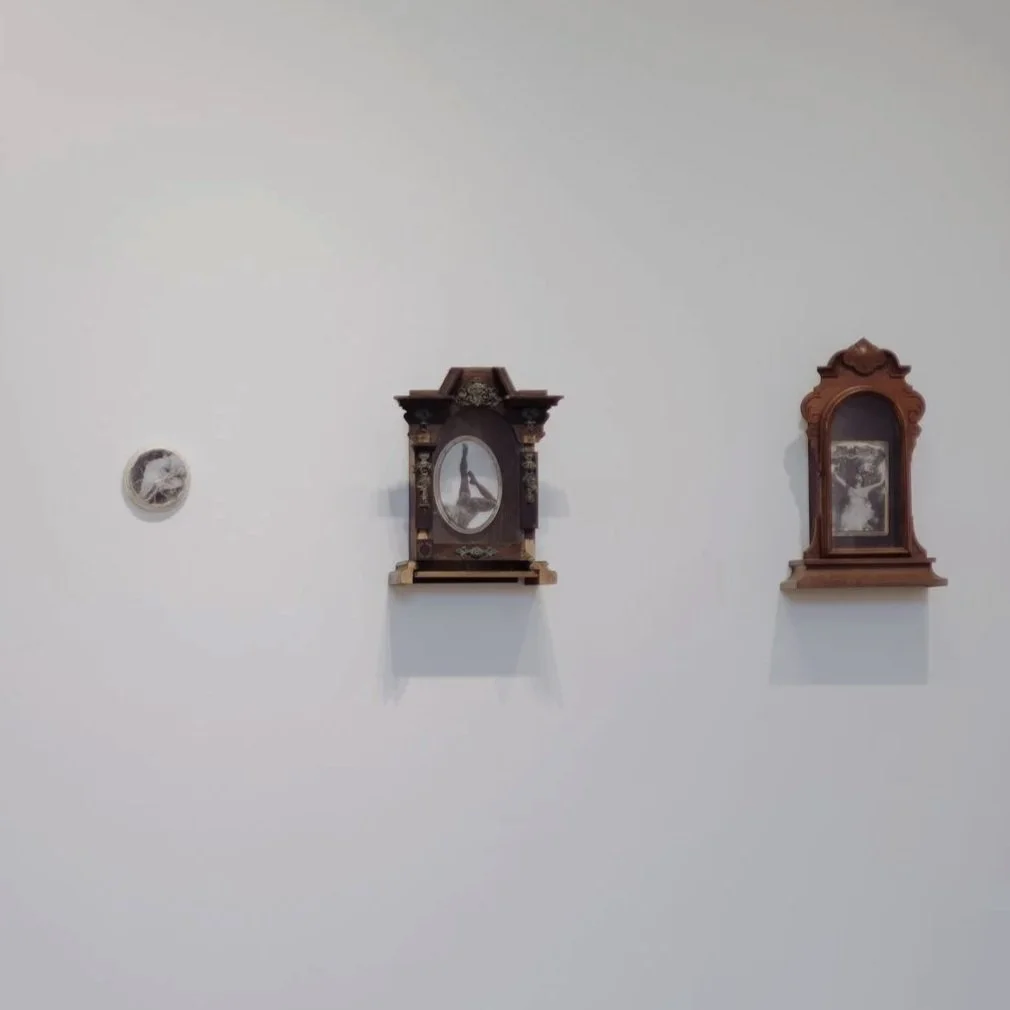 Three framed decorative items hung on a white wall, with shadow effects visible below each frame.