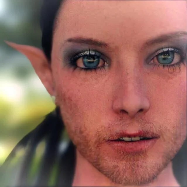 Close-up of a person with blue eyes, elf-like pointed ear, and makeup around the eyes. The person has short dark hair and an intense expression.
