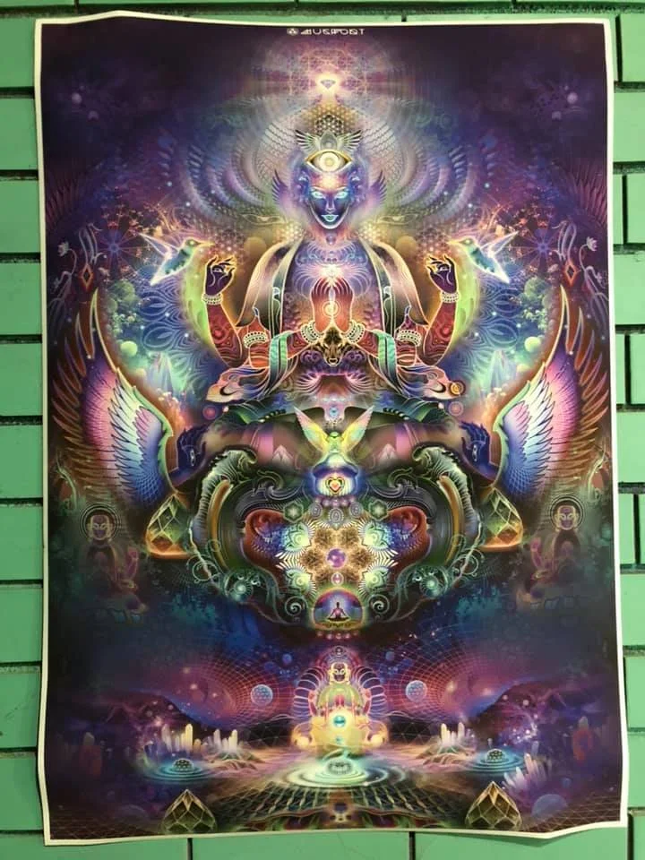 A vibrant, psychedelic artwork depicting a multi-armed, divine figure with an eye on forehead, surrounded by colorful, glowing abstract patterns, animals, and spiritual symbols.