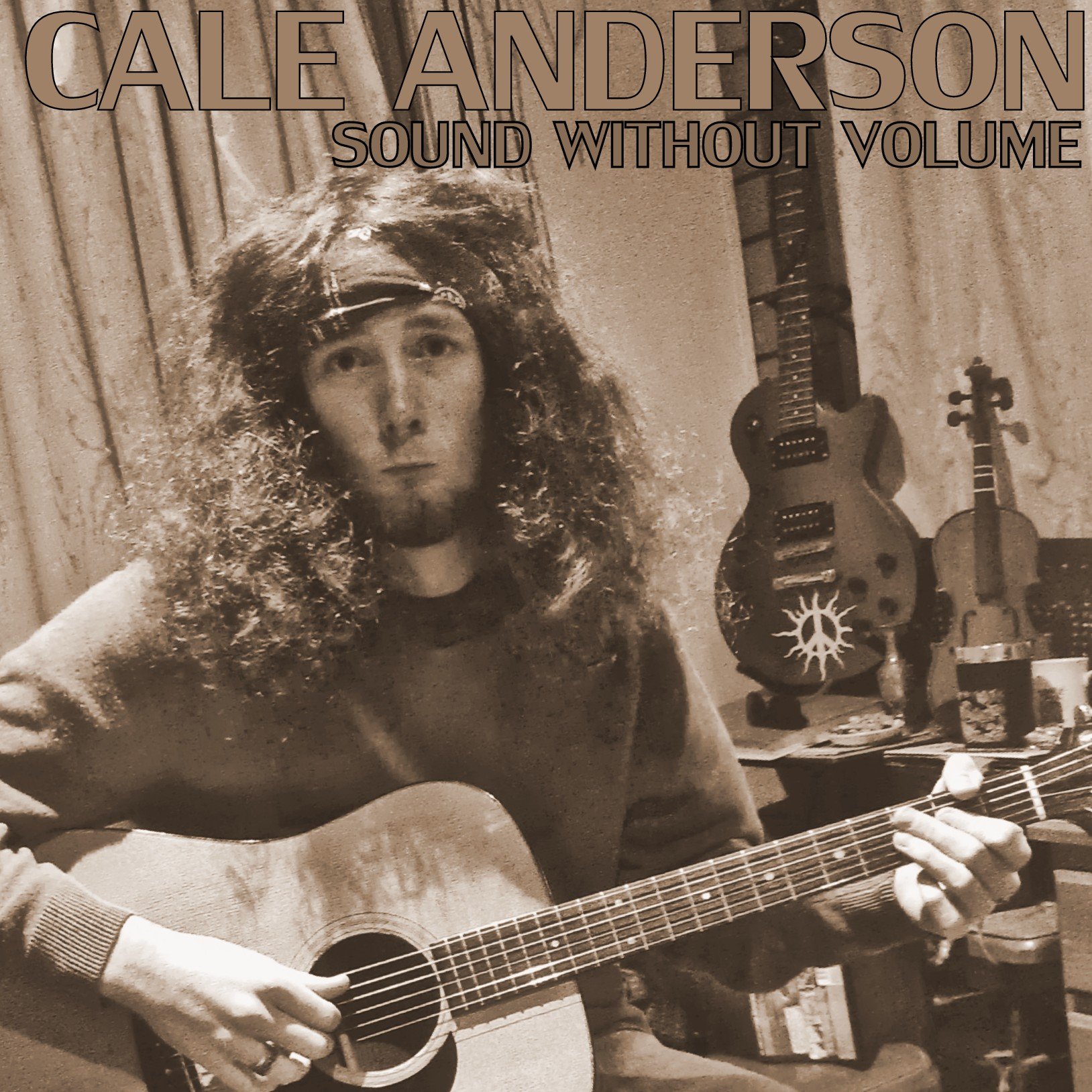 A black-and-white photo of a man with long curly hair and a headband, playing an acoustic guitar in a room with musical instruments and recording equipment in the background. The album cover titled 'Sound Without Volume' by Cale Anderson is displayed