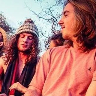 Group of young people outdoors, engaged in conversation.