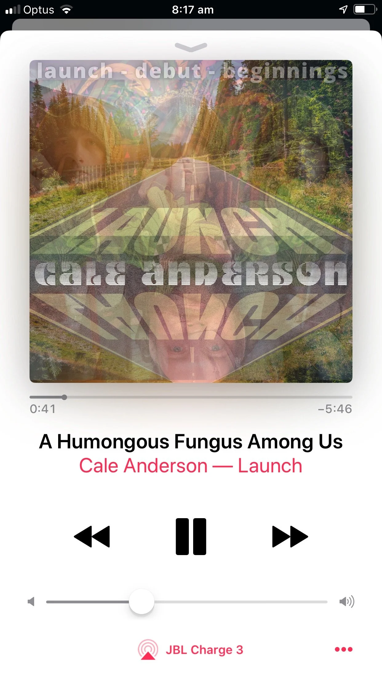 The screen shows a music player playing the song "A Humongous Fungus Among Us" by Cale Anderson from the album "Launch." The album artwork features a collage of multiple overlaid images, including a person, a road, trees, and a road sign that says "l