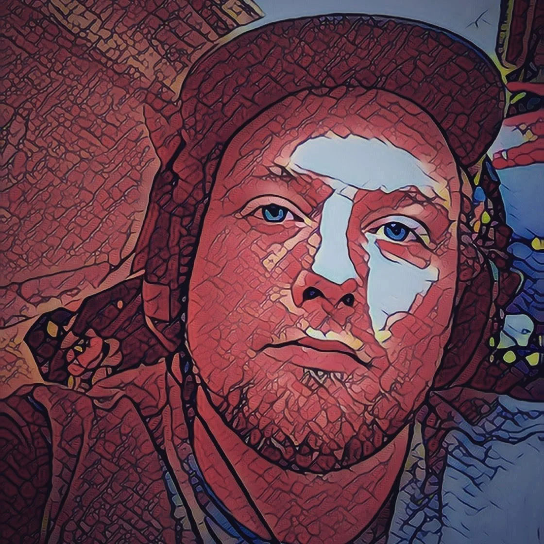 Stylized digital illustration of a man wearing a hoodie and cap, with blue eyes and a serious expression.