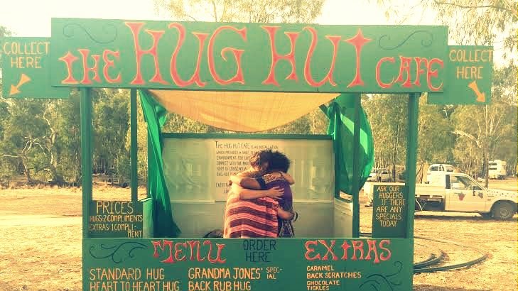 Hug Hut Cafe, Cale Anderson hugs a white guy and  a black guy