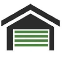 A garage with a green roll-up door under a gabled roof