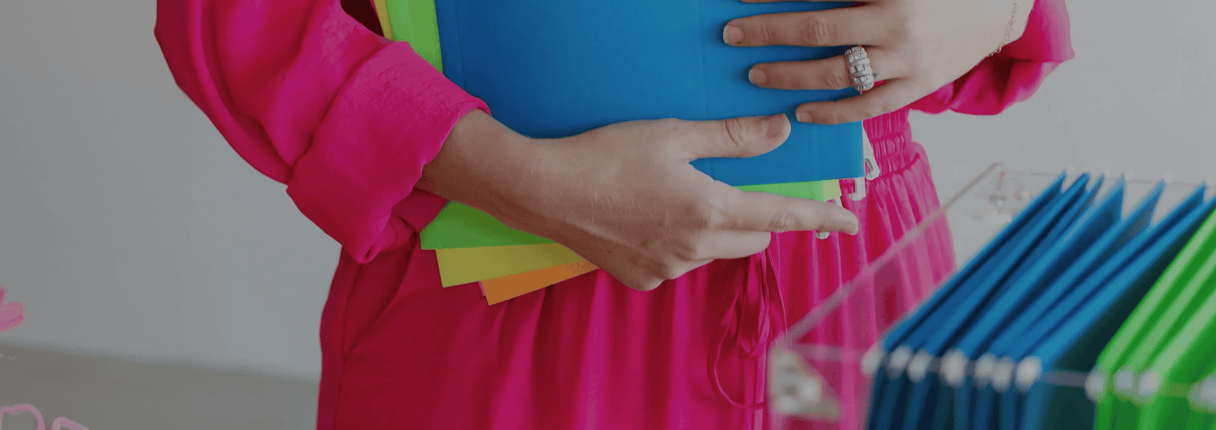 Woman holding colorful folders