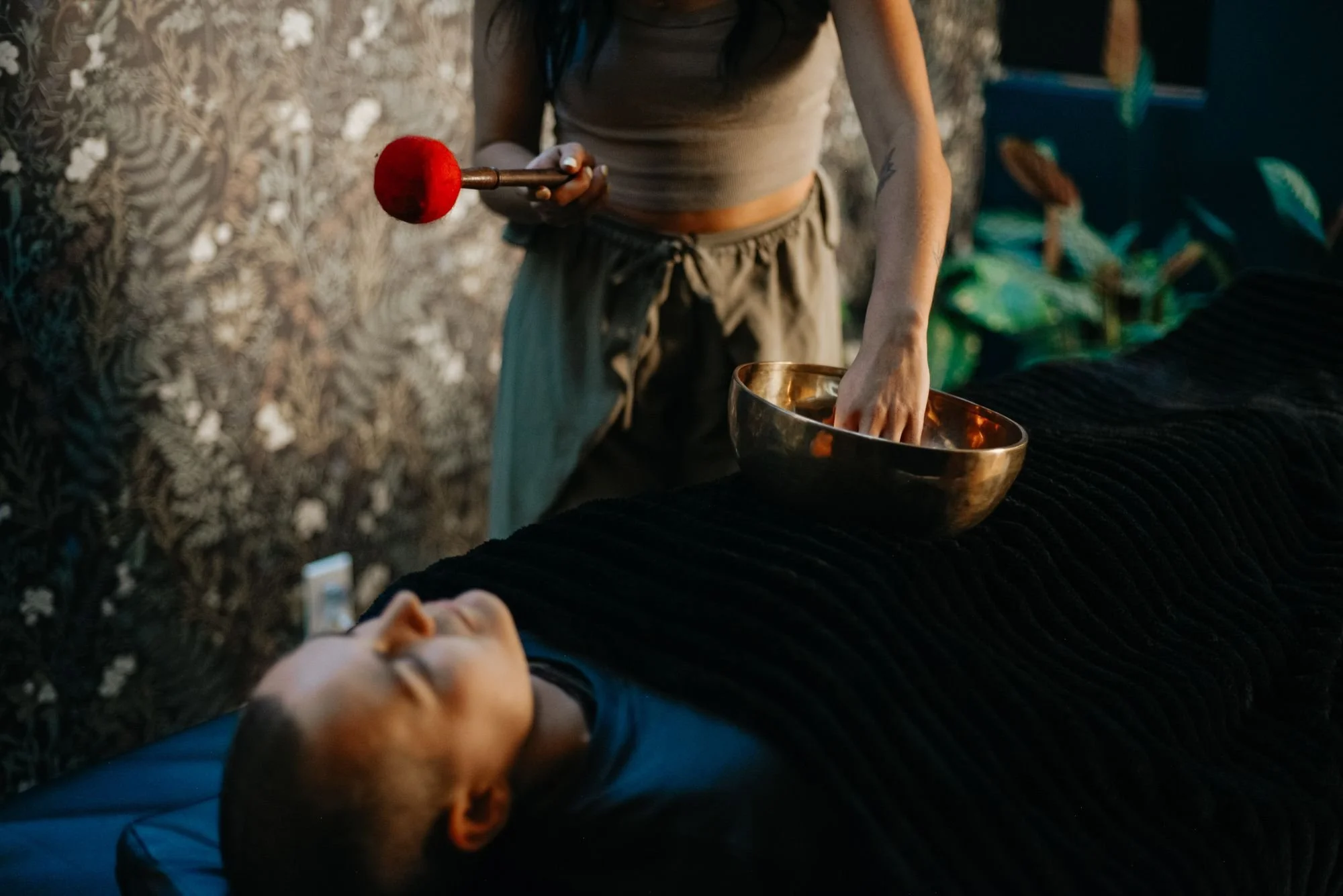 Private sound bath with a singing bowl resting on the body at The Den Wellness Collective in Vancouver
