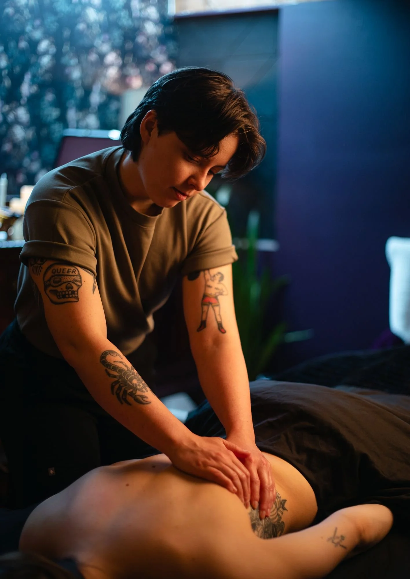 Registered massage therapist treating back tension at The Den Wellness Collective in Vancouver