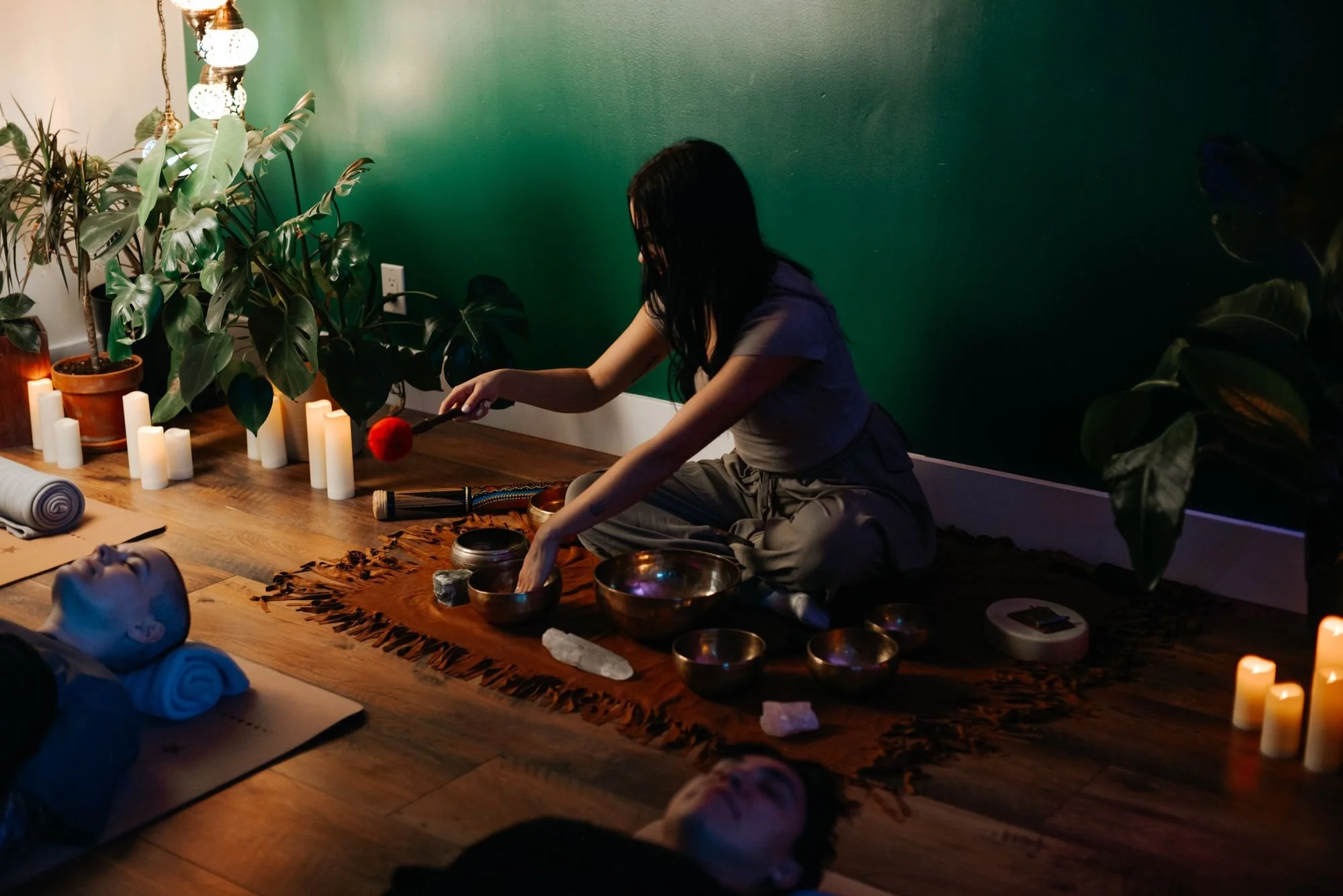 Candlelit group sound bath with singing bowls at The Den Wellness Collective in Vancouver