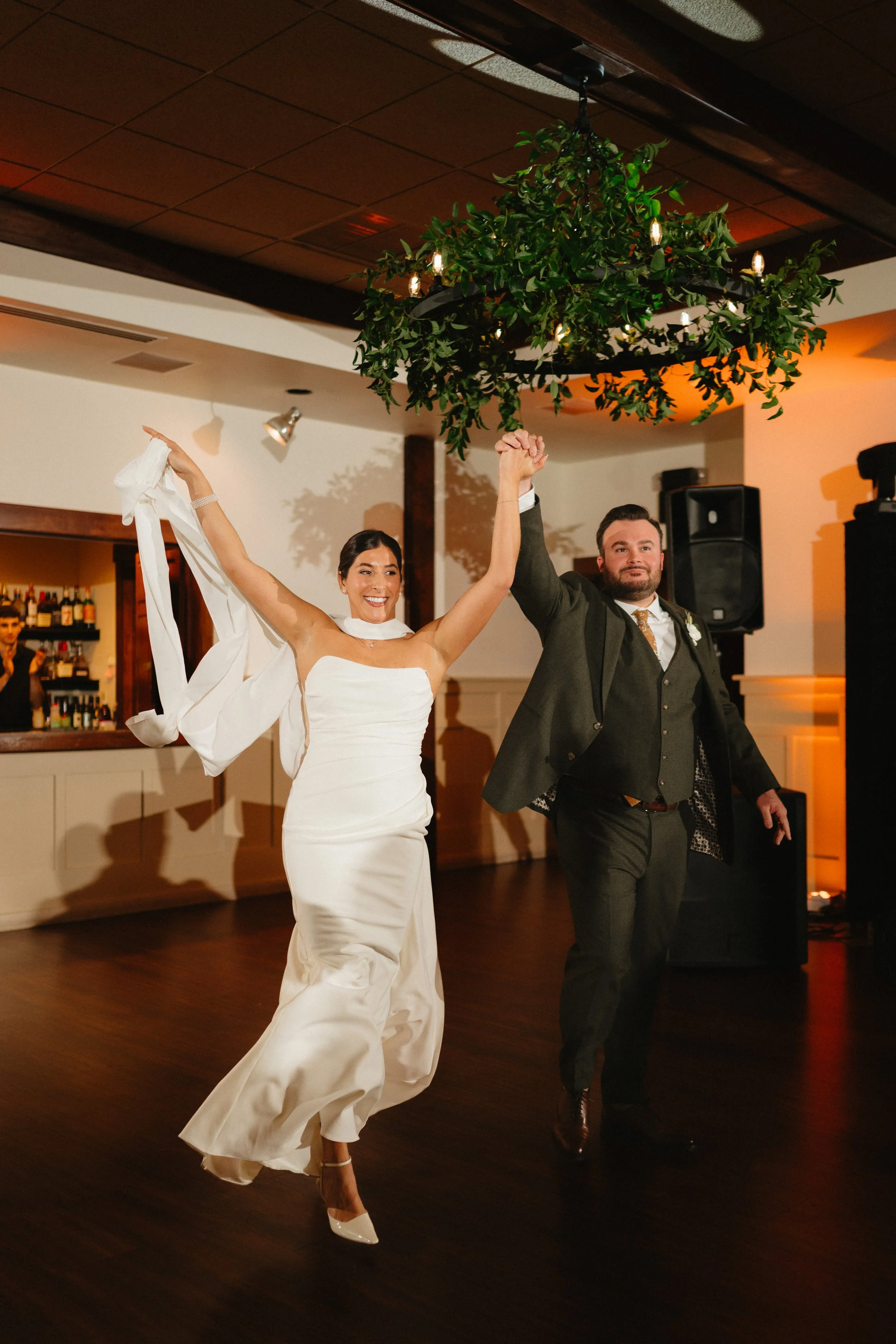 Hawk Pointe Golf Club- Washington NJ-groom holding bride in an embrace in front of fams silos- bride and groom at wedding with arms raised in celebration.jpg