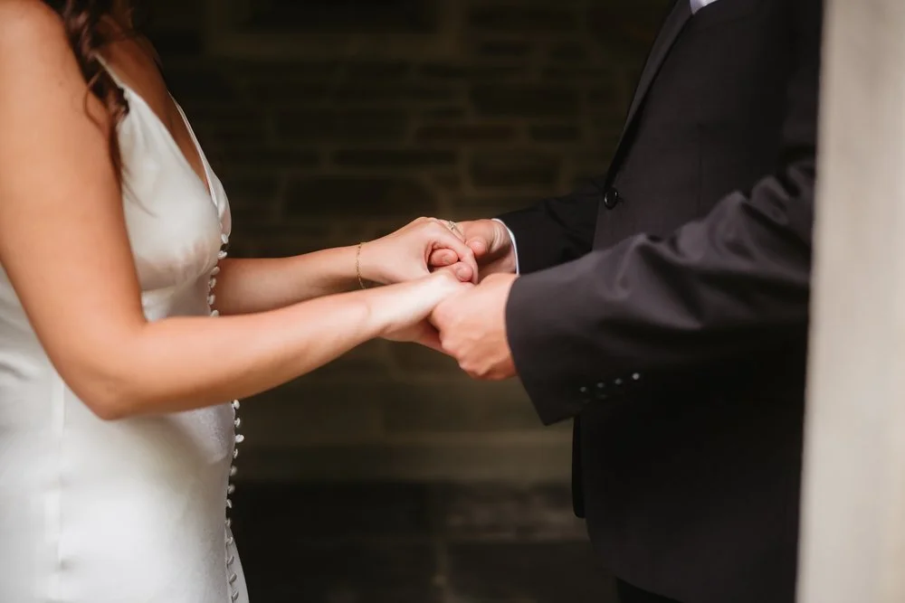 Bride and groom holding hands during wedding