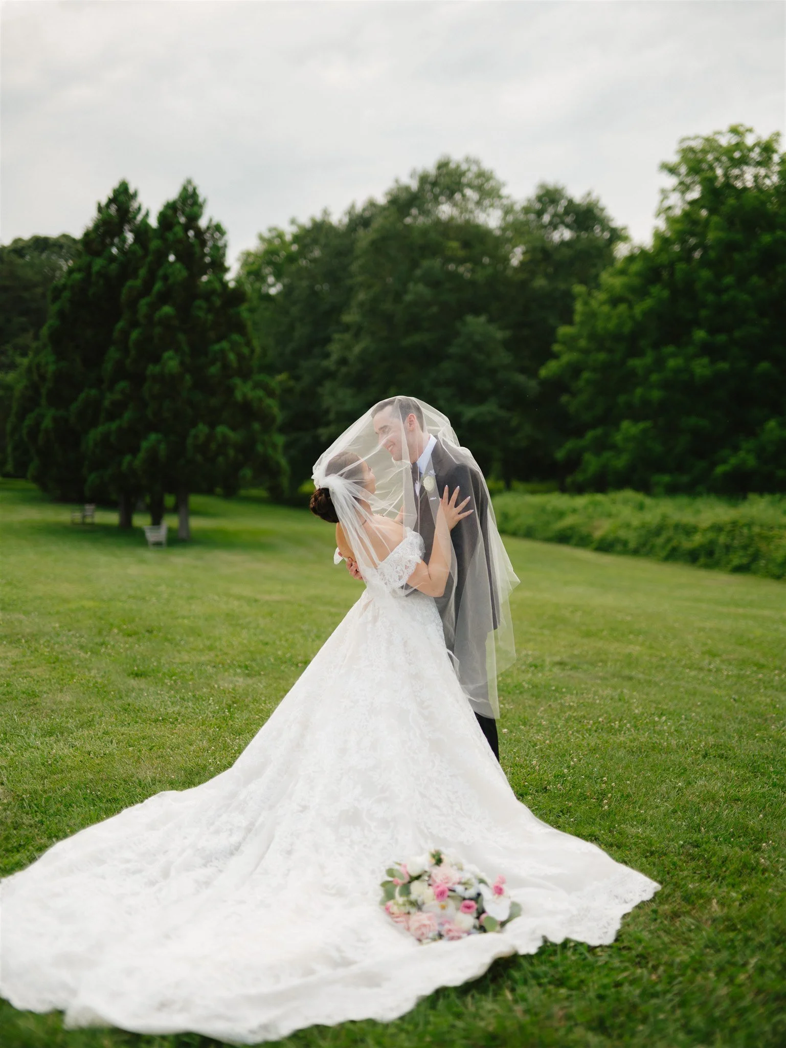 The Palace at Somerset Park-Somerset, NJ-bride and groom kissing in field.jpg