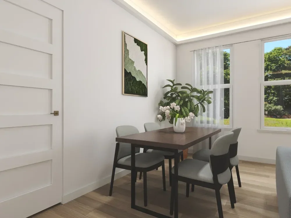 Backyard ADU Modern dining room with a wooden table, four chairs, white floral centerpiece, wall art, and large windows.