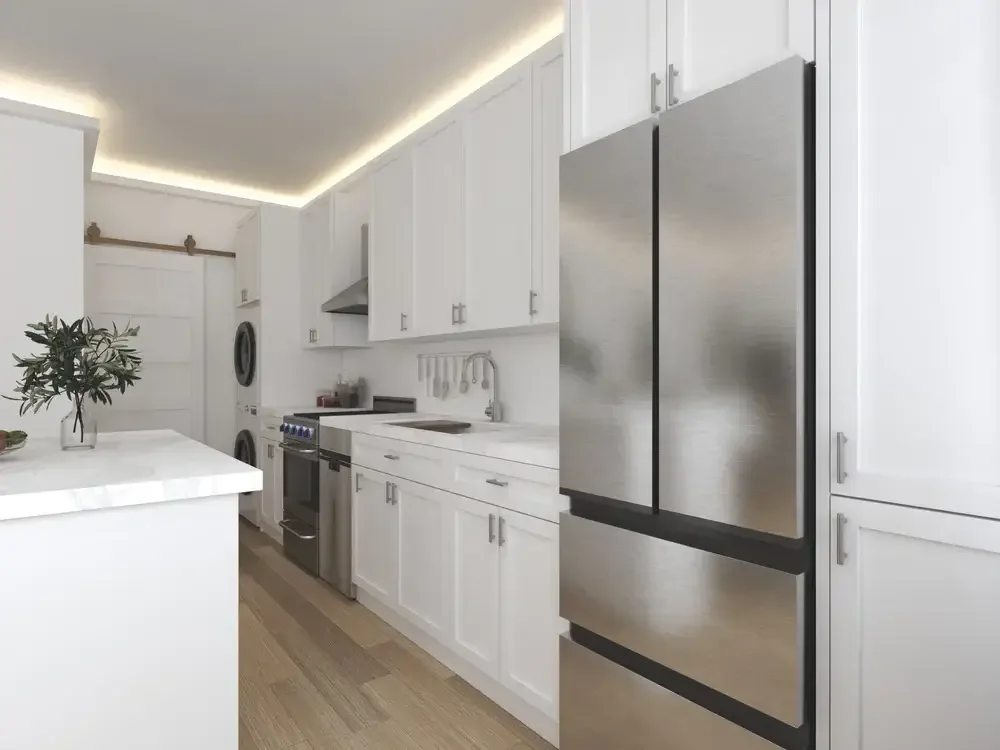 Backyard ADU Modern kitchen with white cabinets, stainless steel appliances, island with marble countertop, and wood flooring.