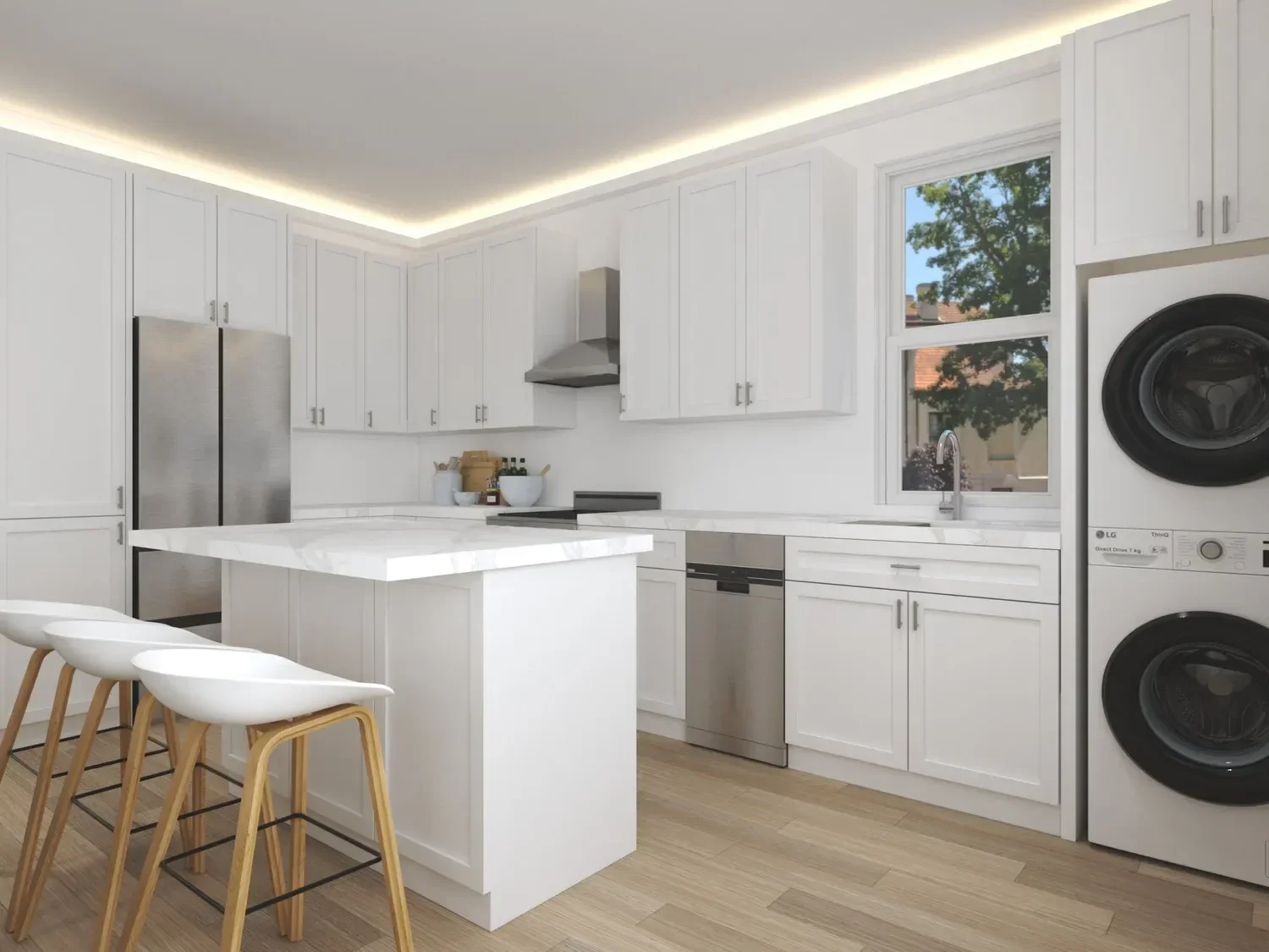 Backyard ADU Modern kitchen with white cabinets, marble countertops, stainless steel appliances, and a stacked washer and dryer. Features an island with bar stools and a window with a view of trees.