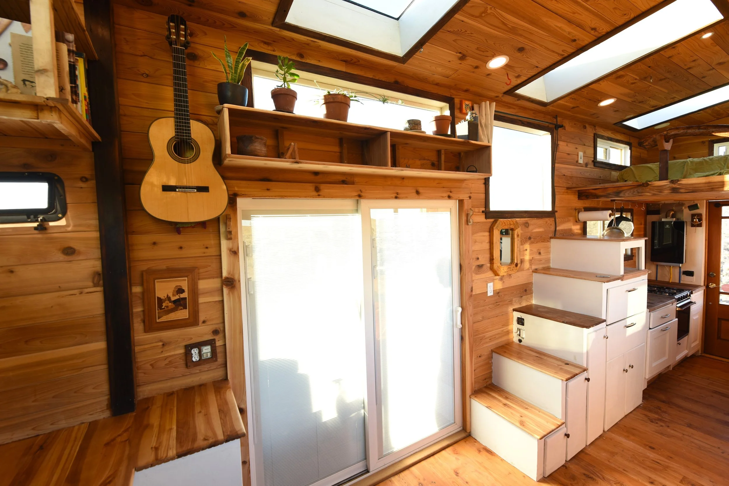 Tiny house sliding glass door and loft stairs