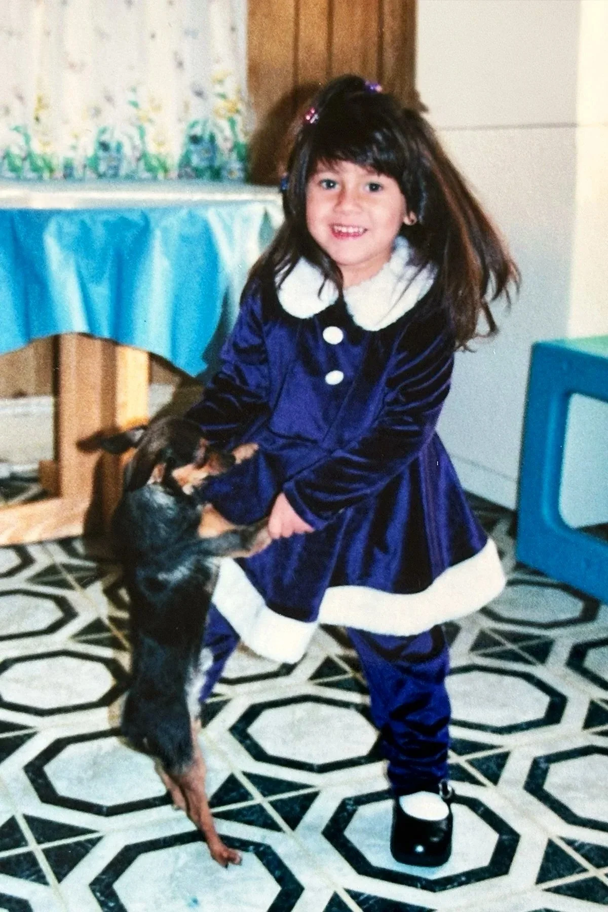 Childhood photograph of Lexis with her family dog, inspiring her passion for meaningful pet portrait photography.