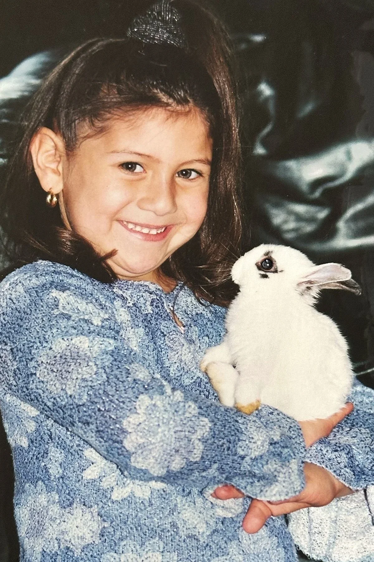 Childhood photo of Lexis holding a white bunny, reflecting the lifelong inspiration behind Little & Loyal Studio.