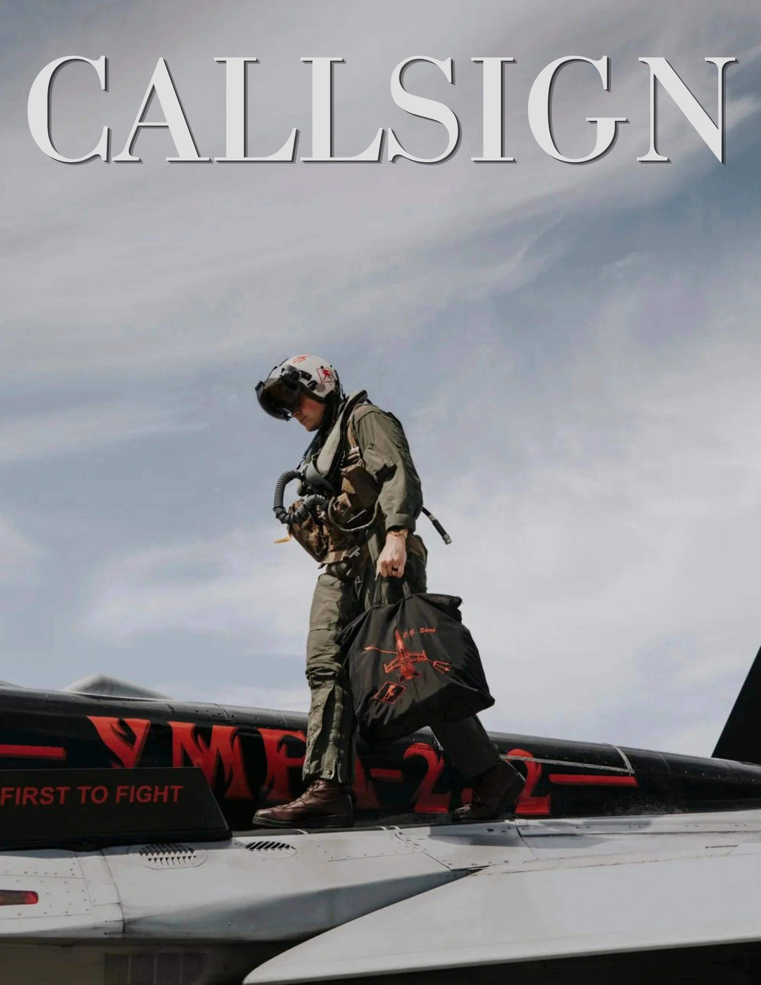 A person in pilot gear standing on the wing of a fighter jet with a cloudy sky in the background.