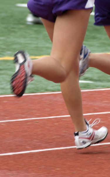Athlete mid stride on an outdoor athletics track during training