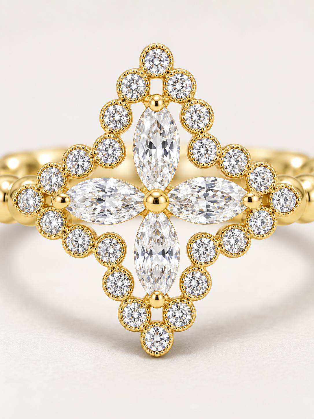 Macro view of the AIR Marquise Flower Ring showing four natural marquise diamonds and round diamonds set in 18K yellow gold.