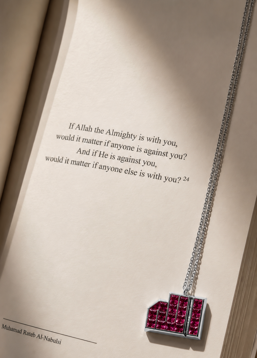 18K white gold pink sapphire pendant resting on an open book, featuring the geometric ALLAH calligraphy design.