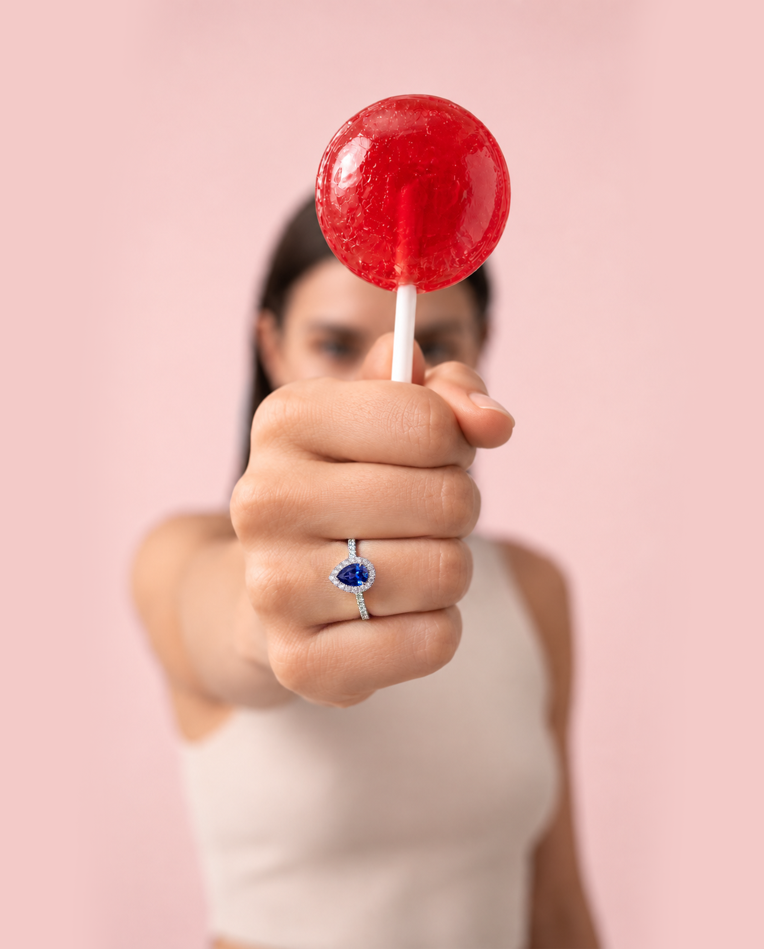 VIVI Pear Blue Sapphire Ring worn on the hand, featuring a natural pear-shaped blue sapphire surrounded by round diamonds.