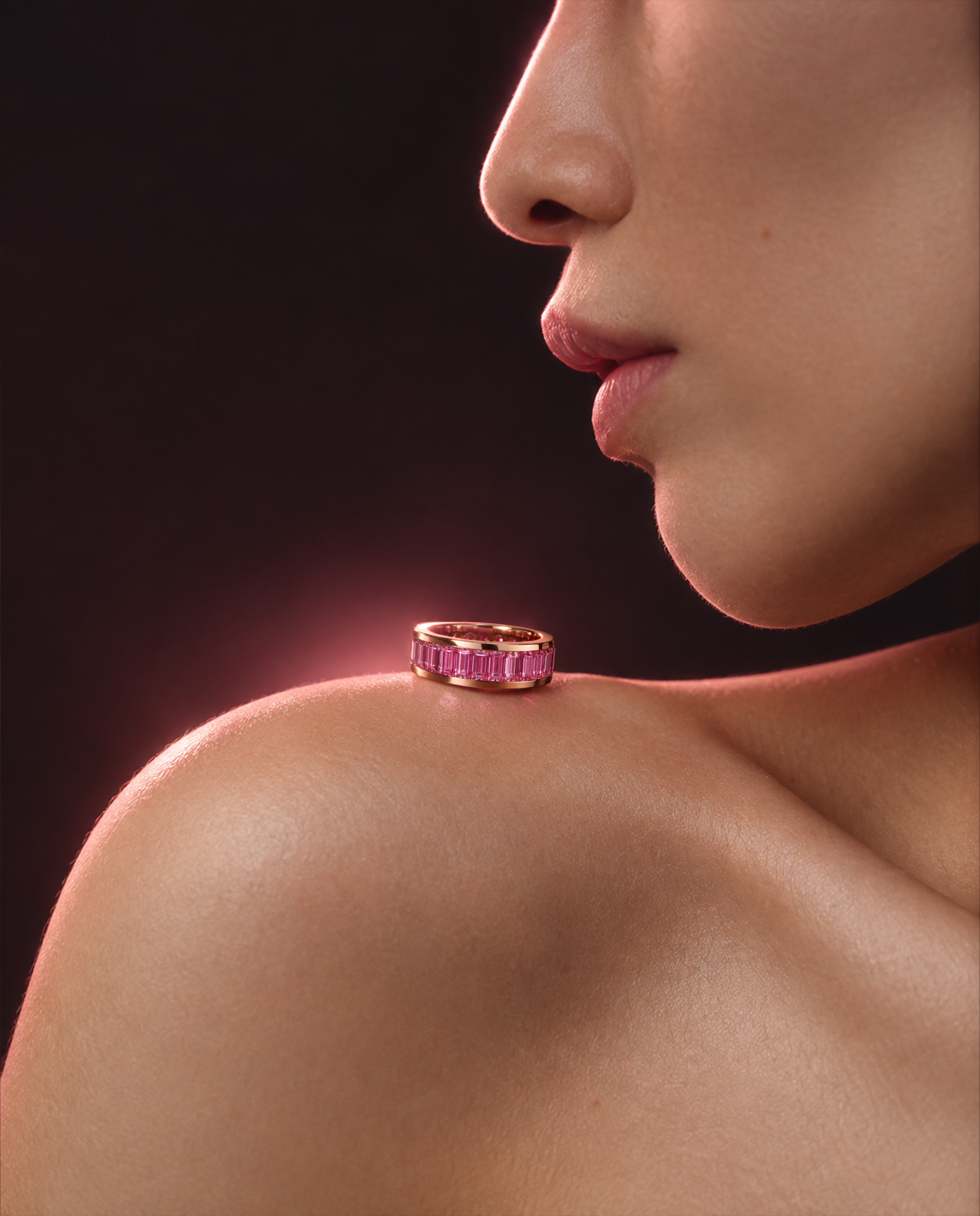 INFINÉ Pink Sapphire Ring styled on the shoulder, featuring natural baguette-cut pink sapphires in an 18K rose gold eternity band.