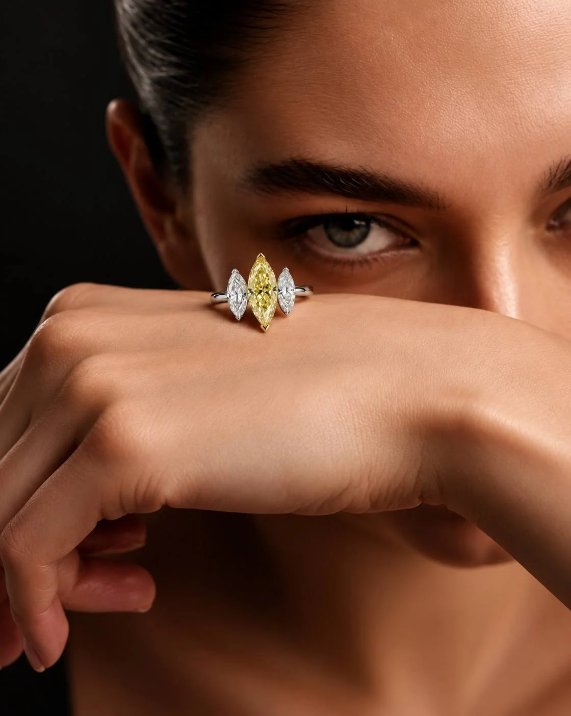 Close-up of the SUNÉ Marquise three-stone ring worn on the hand, highlighting its elongated marquise diamonds and Fancy Yellow center.