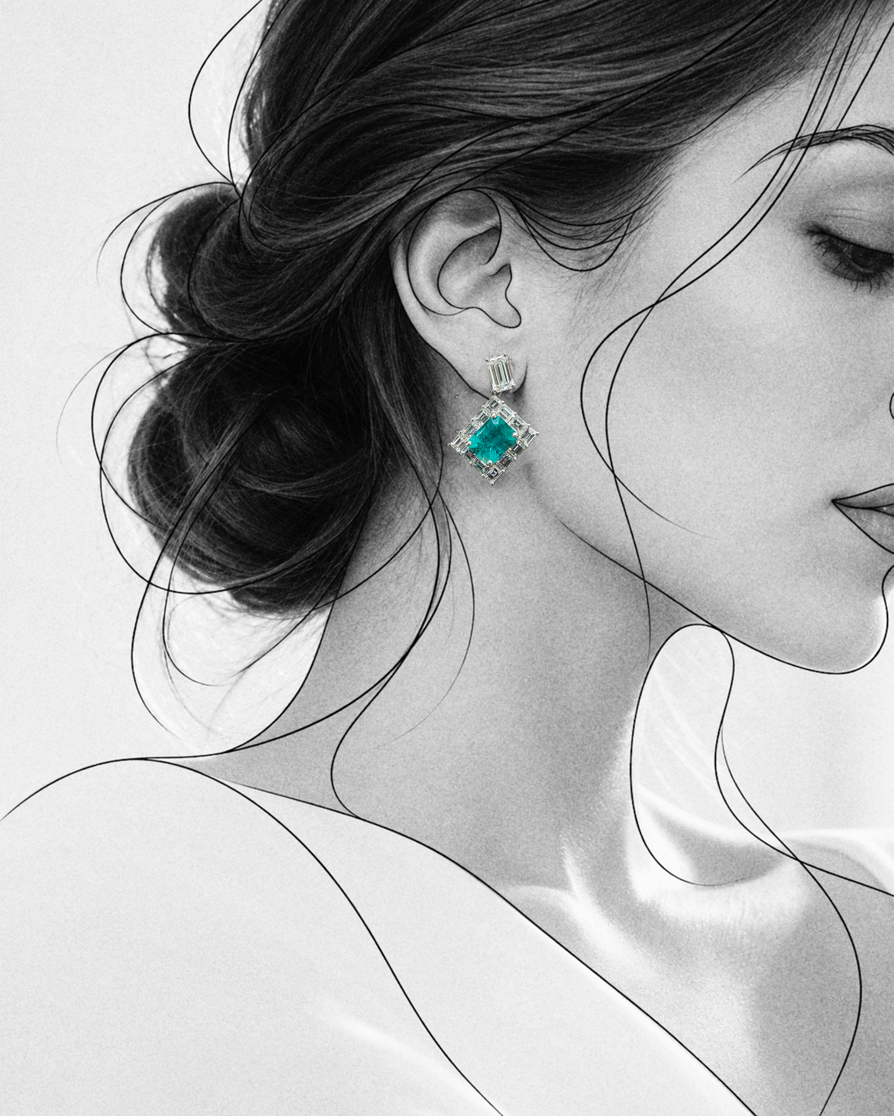 An editorial black-and-white portrait highlighting the CADRE Earrings by AMIRAMIR Genève. A vivid green Colombian emerald surrounded by natural baguette diamonds creates a striking contrast against th