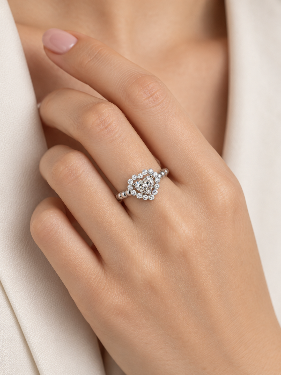 AIR Heart Diamond Ring worn on the hand, showing the heart-shaped center diamond, open halo design and rounded gold band.