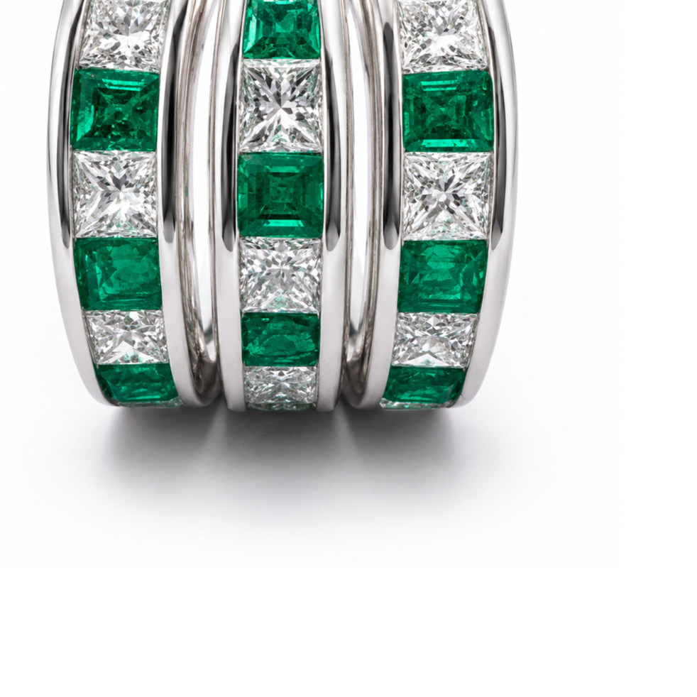 Front view of the Princess Trio Ring showing three parallel rows of natural Colombian emeralds and princess-cut diamonds.