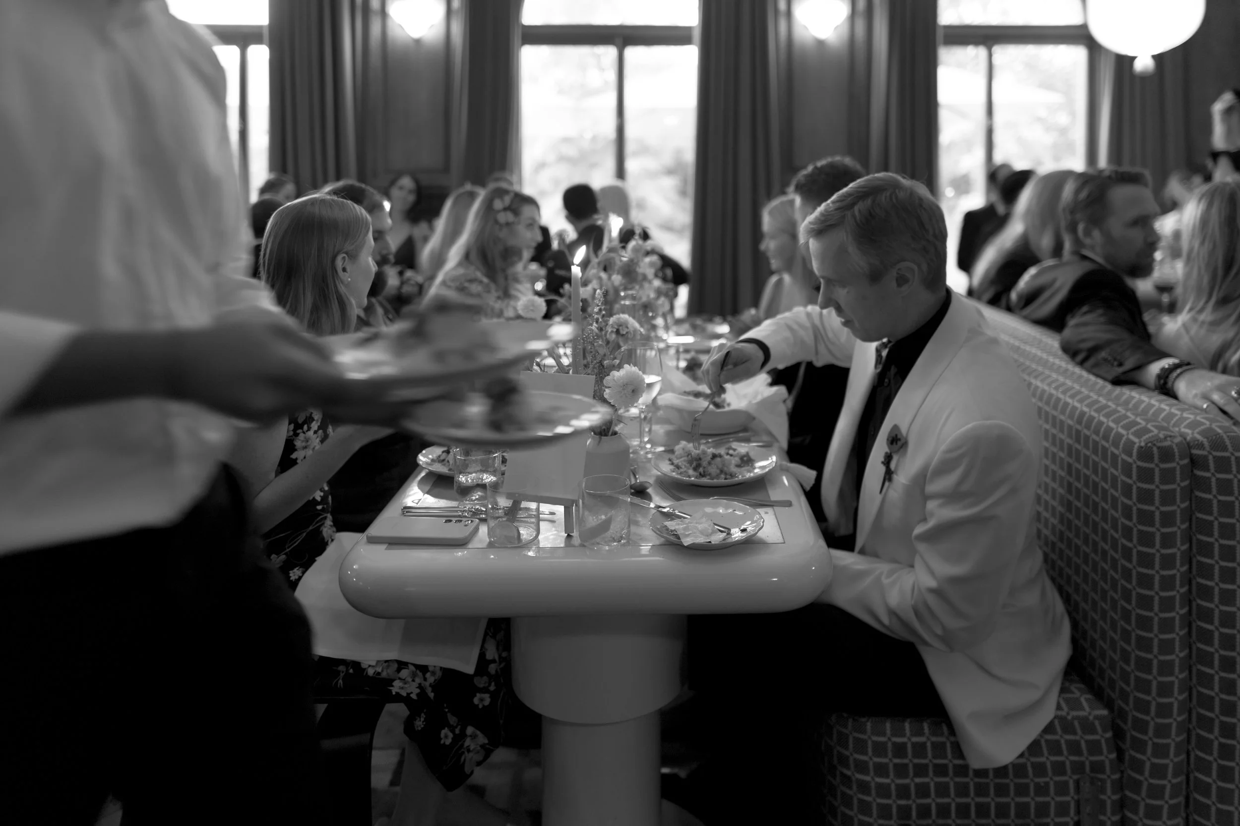 People dining at a long table in the restaurant at Cowley Manor Experimental.