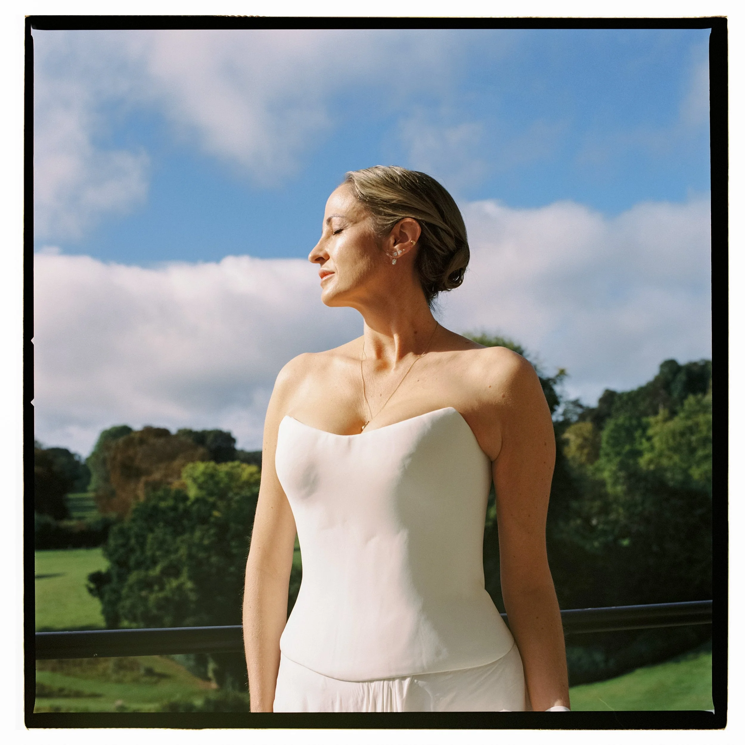 A bride in a custom Angeline Brunk Studio wedding dress at Cowley Manor Experimental.
