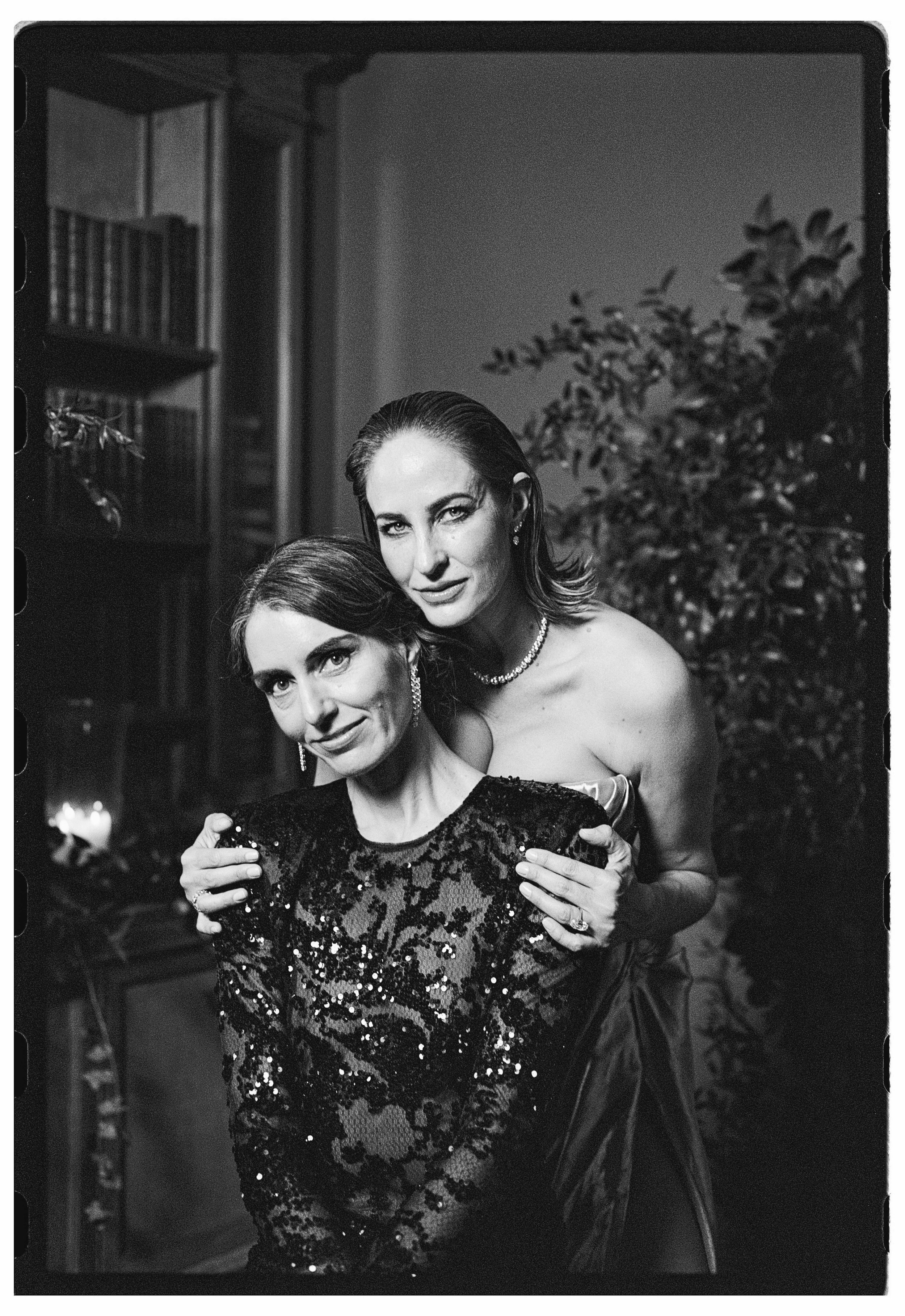Two brides in elegant dresses pose for their portrait on 35mm film at Cowley Manor Experimental.